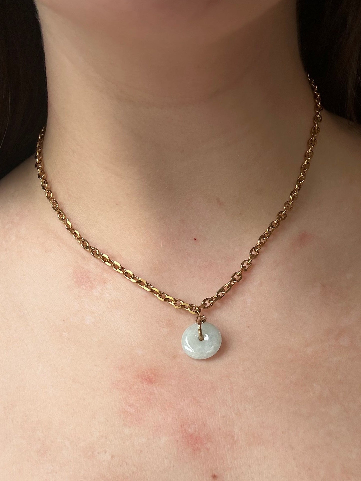 Necklace with a pendant on a person's neck