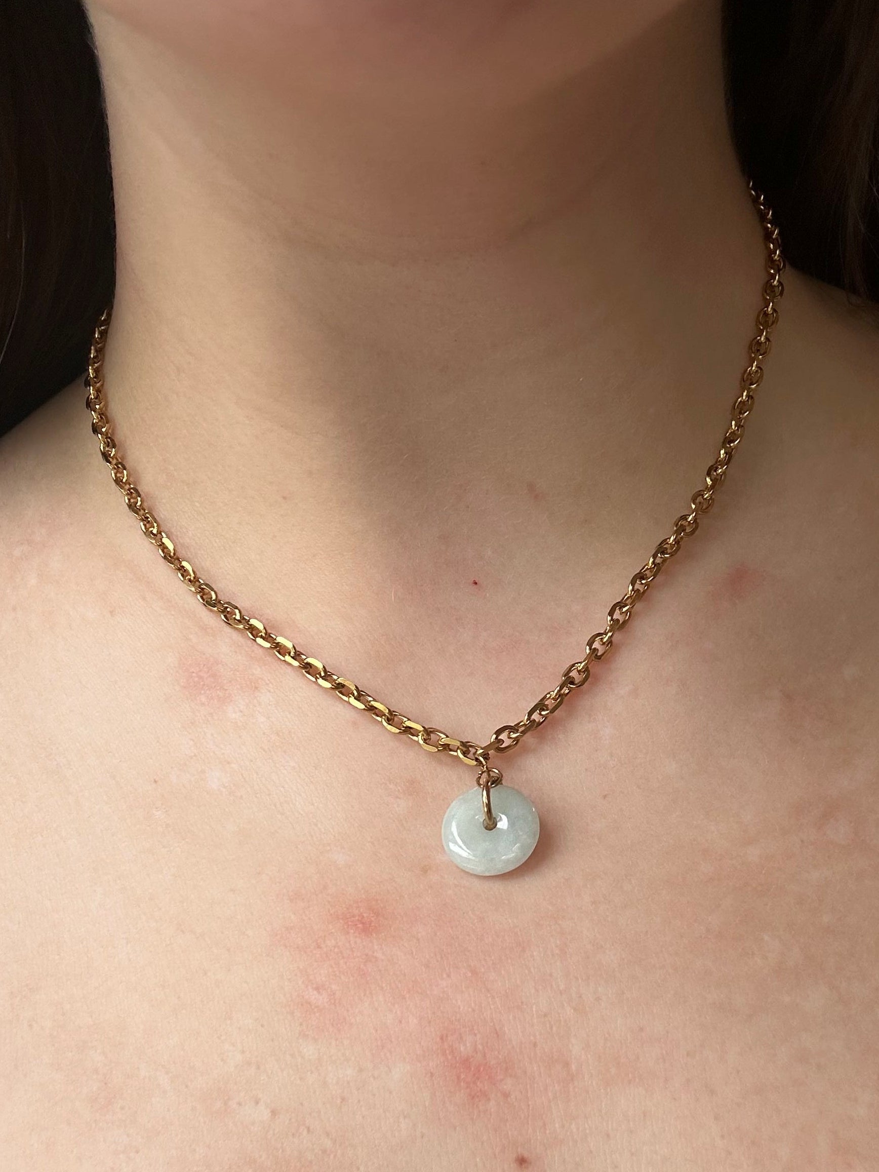 Necklace with a pendant on a person's neck