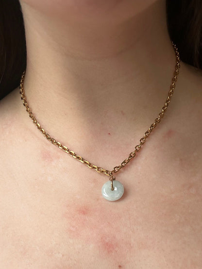 Necklace with a pendant on a person's neck