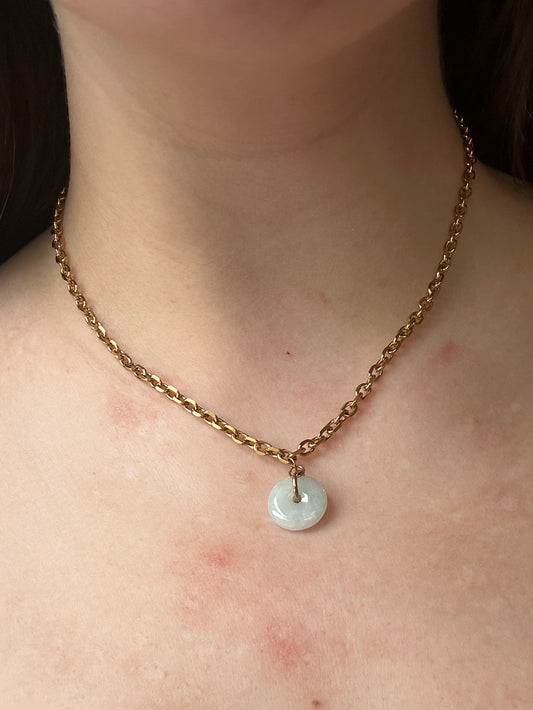 Necklace with a pendant on a person's neck